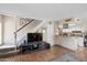 Inviting living room showcases a staircase, entertainment center, and neutral color palette at 8653 S 51St St # 2, Phoenix, AZ 85044