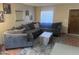 Living room featuring tile flooring, a large sectional couch, decor, and bright natural light at 8653 S 51St St # 2, Phoenix, AZ 85044
