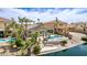Serene backyard featuring a pool, landscaping, and lake views, perfect for outdoor entertaining at 896 E Indian Wells Pl, Chandler, AZ 85249