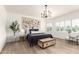 Serene main bedroom with neutral tones, wood floors, plantation shutters, and a decorative chandelier at 896 E Indian Wells Pl, Chandler, AZ 85249