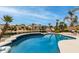 Beautiful pool overlooking the lake with palm trees and a blue sky backdrop at 896 E Indian Wells Pl, Chandler, AZ 85249