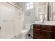 Bathroom with a shower over bath, toilet, vanity with dark wood cabinet at 913 W Yosemite Dr, Chandler, AZ 85248