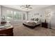 Cozy bedroom with plush carpet, a ceiling fan, and natural light at 913 W Yosemite Dr, Chandler, AZ 85248