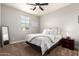 Bedroom features carpeted floors, a ceiling fan and a cozy bed at 913 W Yosemite Dr, Chandler, AZ 85248