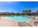 Inviting community pool surrounded by lounge chairs, lush landscaping, and palm trees at 913 W Yosemite Dr, Chandler, AZ 85248