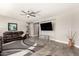 Cozy living room featuring a flat-screen TV, tile flooring, and comfortable sofa at 913 W Yosemite Dr, Chandler, AZ 85248