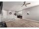 Open loft area with neutral carpet, a ceiling fan, staircase and built-in cabinets at 913 W Yosemite Dr, Chandler, AZ 85248