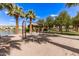 Community playground with swings, a sandy play area, and a lovely view of the lake at 913 W Yosemite Dr, Chandler, AZ 85248