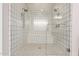 Glass enclosed shower featuring white tile walls, built-in seating, and dual shower heads at 913 W Yosemite Dr, Chandler, AZ 85248