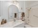 Clean bathroom showcasing a vanity with a stone countertop, a mirrored wall cabinet and a shower at 9265 N 111Th Ave, Sun City, AZ 85351