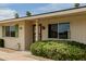 Exterior view showcases covered front porch, desert landscape, and picture window at 9265 N 111Th Ave, Sun City, AZ 85351