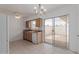 Bright kitchen featuring tile floors, neutral counters, and a sliding glass door to the outdoor patio at 9265 N 111Th Ave, Sun City, AZ 85351