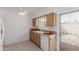 A bright kitchen featuring a window view of the outside and a tiled floor and countertop at 9265 N 111Th Ave, Sun City, AZ 85351