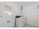 Functional laundry room with a washing machine and door to the outside at 9265 N 111Th Ave, Sun City, AZ 85351