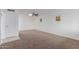 Open-concept living area features modern ceiling fan and neutral carpet flooring at 9265 N 111Th Ave, Sun City, AZ 85351