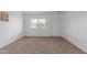 Spacious carpeted living room filled with natural light from the large picture window at 9265 N 111Th Ave, Sun City, AZ 85351