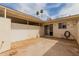 An outdoor patio with a sliding glass door, and block fence for privacy at 9265 N 111Th Ave, Sun City, AZ 85351