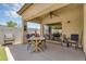 Covered back patio with dining table and seating, ideal for outdoor meals and gatherings at 948 E Savannah Dr, Chandler, AZ 85225