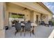 Spacious covered patio with seating, a dining table and decorative elements for outdoor enjoyment at 948 E Savannah Dr, Chandler, AZ 85225