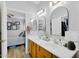 Bright bathroom featuring a double sink vanity, stylish mirrors, and neutral decor at 948 E Savannah Dr, Chandler, AZ 85225