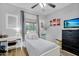 Another view of the light-filled bedroom with a work space and a cozy bed at 948 E Savannah Dr, Chandler, AZ 85225