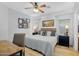 Bright bedroom with a large bed, decorative pillows, framed artwork, and matching nightstands at 948 E Savannah Dr, Chandler, AZ 85225