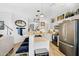 Open kitchen featuring white cabinets, stainless steel appliances, and stylish pendant lighting at 948 E Savannah Dr, Chandler, AZ 85225
