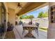 Inviting outdoor patio with a dining area, ceiling fan, and a serene backyard view at 948 E Savannah Dr, Chandler, AZ 85225