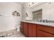 This bathroom has a cherry wood vanity, decorative mirror, and neutral paint at 9820 N Central Ave # 321, Phoenix, AZ 85020