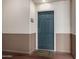 Condo front door is painted a sleek blue-gray with a modern six-panel design at 9820 N Central Ave # 321, Phoenix, AZ 85020