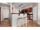 The kitchen overlooks a breakfast bar with seating for a modern open concept living area at 9820 N Central Ave # 321, Phoenix, AZ 85020