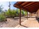 Backyard featuring covered patio, with a brick floor, gravel and shade trees at 10032 N 50Th Dr, Glendale, AZ 85302