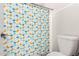 Bathroom showcasing a toilet and shower with an umbrella and duck pattern curtain at 10032 N 50Th Dr, Glendale, AZ 85302