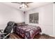 Comfortable bedroom with a large window, queen-size bed, ceiling fan, and wood-style flooring at 10032 N 50Th Dr, Glendale, AZ 85302