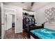 Cozy bedroom featuring dark wood floors, closet, ceiling fan and a window at 10032 N 50Th Dr, Glendale, AZ 85302