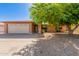 Charming single-story brick home with a two-car garage and a mature shade tree at 10032 N 50Th Dr, Glendale, AZ 85302