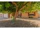 Charming single-story brick home with a two-car garage, long driveway, and mature shade trees at 10032 N 50Th Dr, Glendale, AZ 85302