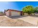 Charming single-story brick home with a two-car garage, long driveway, and low-maintenance landscaping at 10032 N 50Th Dr, Glendale, AZ 85302