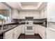 Bright kitchen with white cabinets, dark countertops, and modern appliances at 10032 N 50Th Dr, Glendale, AZ 85302