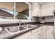 Close-up of the stainless steel kitchen sink and faucet, with ample countertop space at 10032 N 50Th Dr, Glendale, AZ 85302