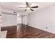 Open living room with wood-look floors, neutral paint, and access to other rooms at 10032 N 50Th Dr, Glendale, AZ 85302