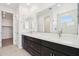 Elegant bathroom with double sink vanity, large mirror, and a view to the shower at 10253 E Ursula Ave, Mesa, AZ 85212