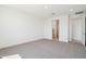 Spacious bedroom with plush carpeting, neutral tones, and access to an ensuite bathroom at 10253 E Ursula Ave, Mesa, AZ 85212