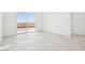 Sunlit bedroom showcases tile floors, a large window, and sliding glass door for backyard access at 10253 E Ursula Ave, Mesa, AZ 85212