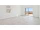 Sunlit bedroom showcases tile floors, a large window, and sliding glass door for backyard access at 10253 E Ursula Ave, Mesa, AZ 85212
