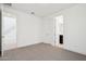 Spacious carpeted bedroom with ensuite bathroom and a view of the stairs at 10253 E Ursula Ave, Mesa, AZ 85212