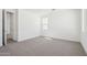 Empty bedroom featuring neutral walls, plush carpet, and natural light from a window at 10253 E Ursula Ave, Mesa, AZ 85212