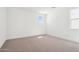 Empty bedroom with neutral walls, carpet, and natural light from a window at 10253 E Ursula Ave, Mesa, AZ 85212