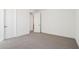 Neutral bedroom with neutral walls and carpet and multiple doors at 10253 E Ursula Ave, Mesa, AZ 85212