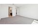 Bright, carpeted bedroom featuring an ensuite bathroom and closet at 10253 E Ursula Ave, Mesa, AZ 85212